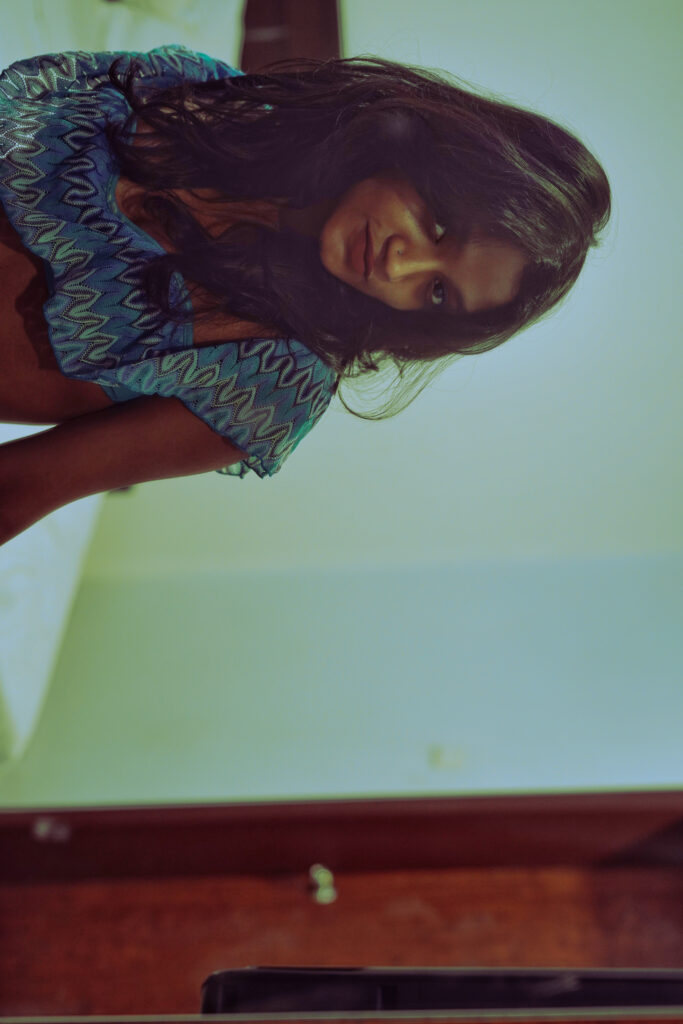 Editorial portrait of a woman in a blue top, photographed upside down