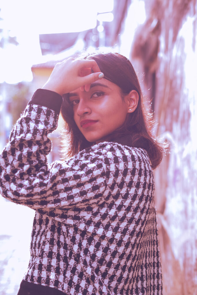 Woman in a houndstooth jacket in an editorial portrait
