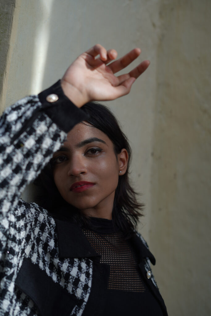 Woman in a houndstooth jacket in an editorial portrait