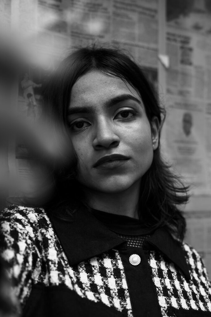 Woman in a houndstooth jacket in an editorial portrait