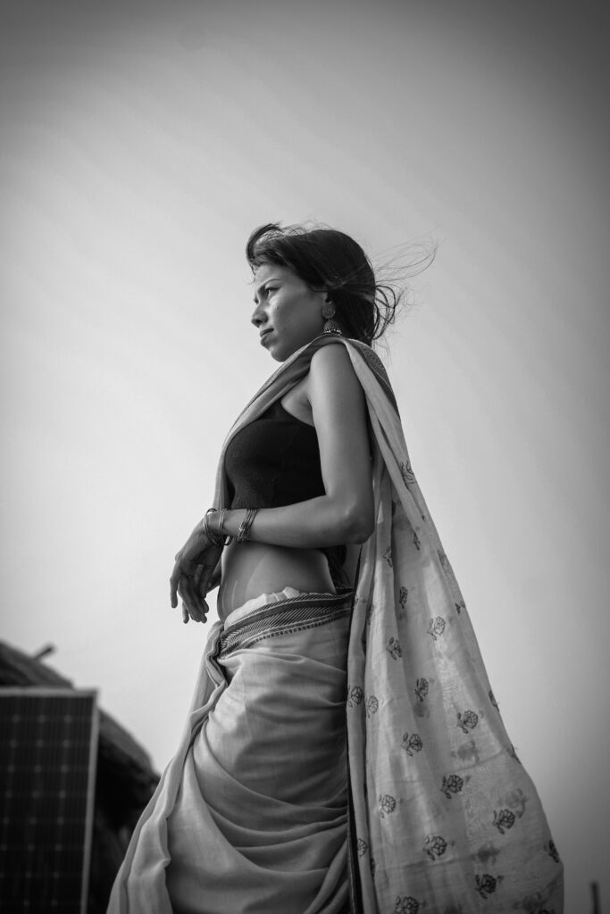 Black and white portrait of a woman in a saree by the river
