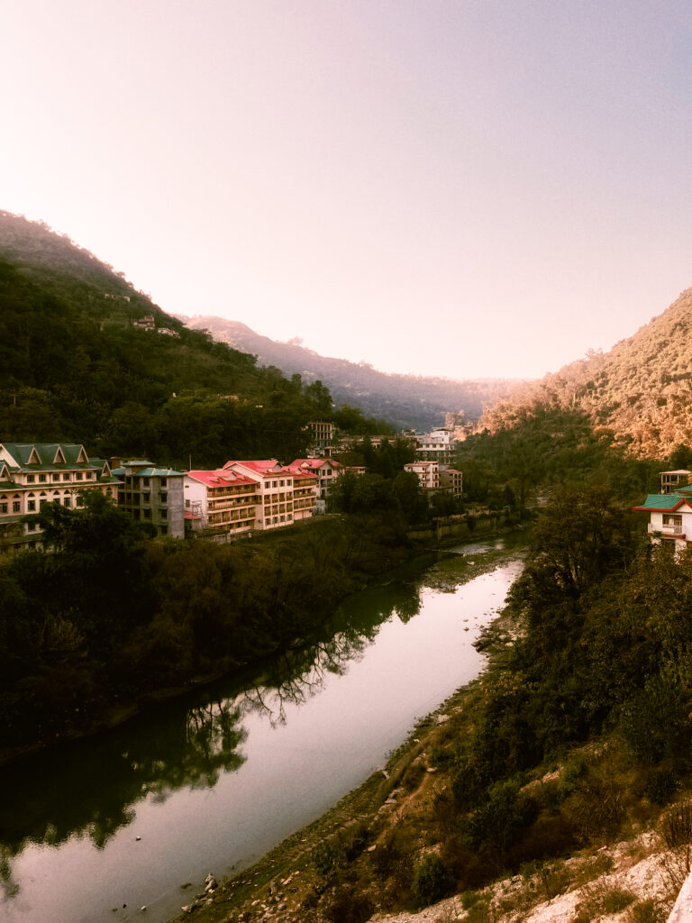 River winding through a green mountain valley with a small town